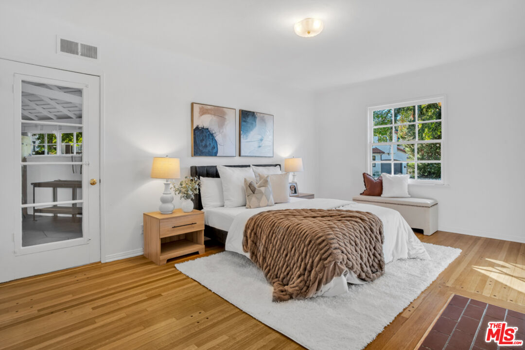 1901 Montecito Drive Glendale, CA 91208 - Photo 29 of 64 a bedroom with a bed and wooden floor