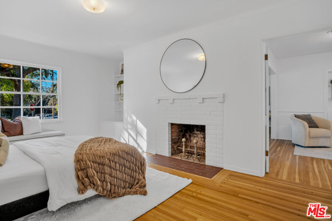 1901 Montecito Drive Glendale, CA 91208 - Photo 30 of 64 a bedroom with a bed a fireplace and a potted plant