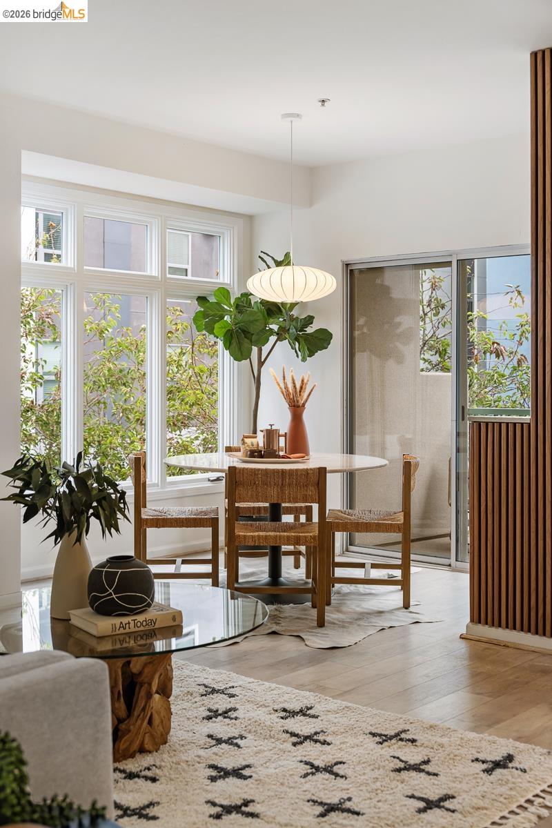 2029 Channing Way, Unit 3D Berkeley, CA 94704 - Photo 7 of 54 Open-concept living area featuring light wood-finish flooring, a large multi-pane window, and a sliding glass door to a private outdoor space