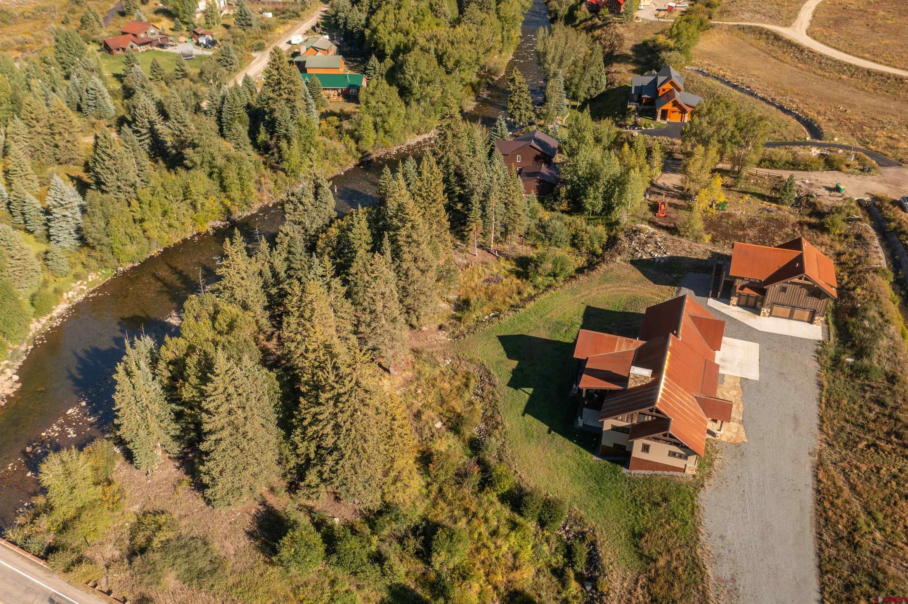 an aerial view of a house with a yard