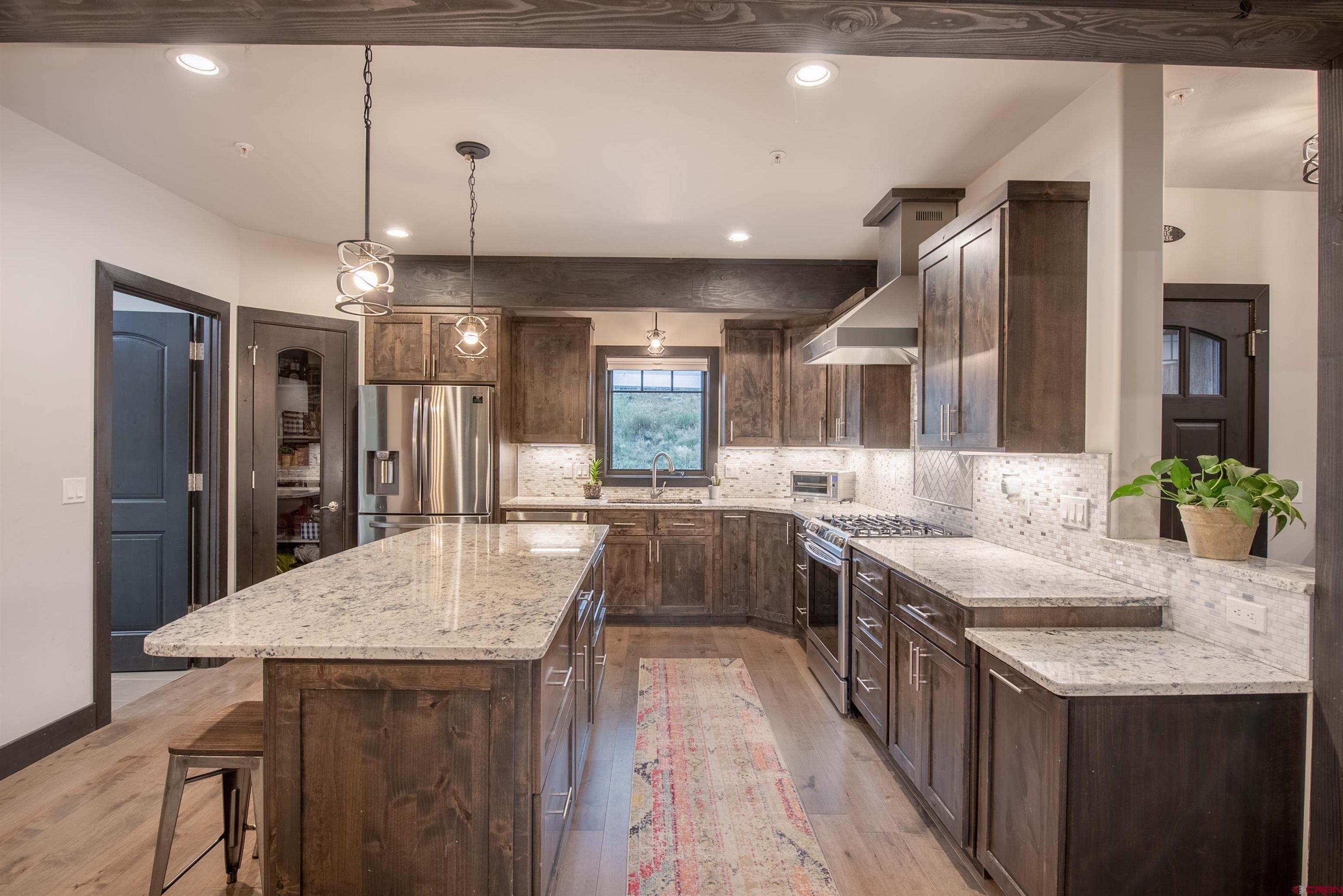 23 Jacquelyn Lane Crested Butte, CO 81224 - Photo 11 of 33 a large kitchen with kitchen island a sink appliances and a dining table
