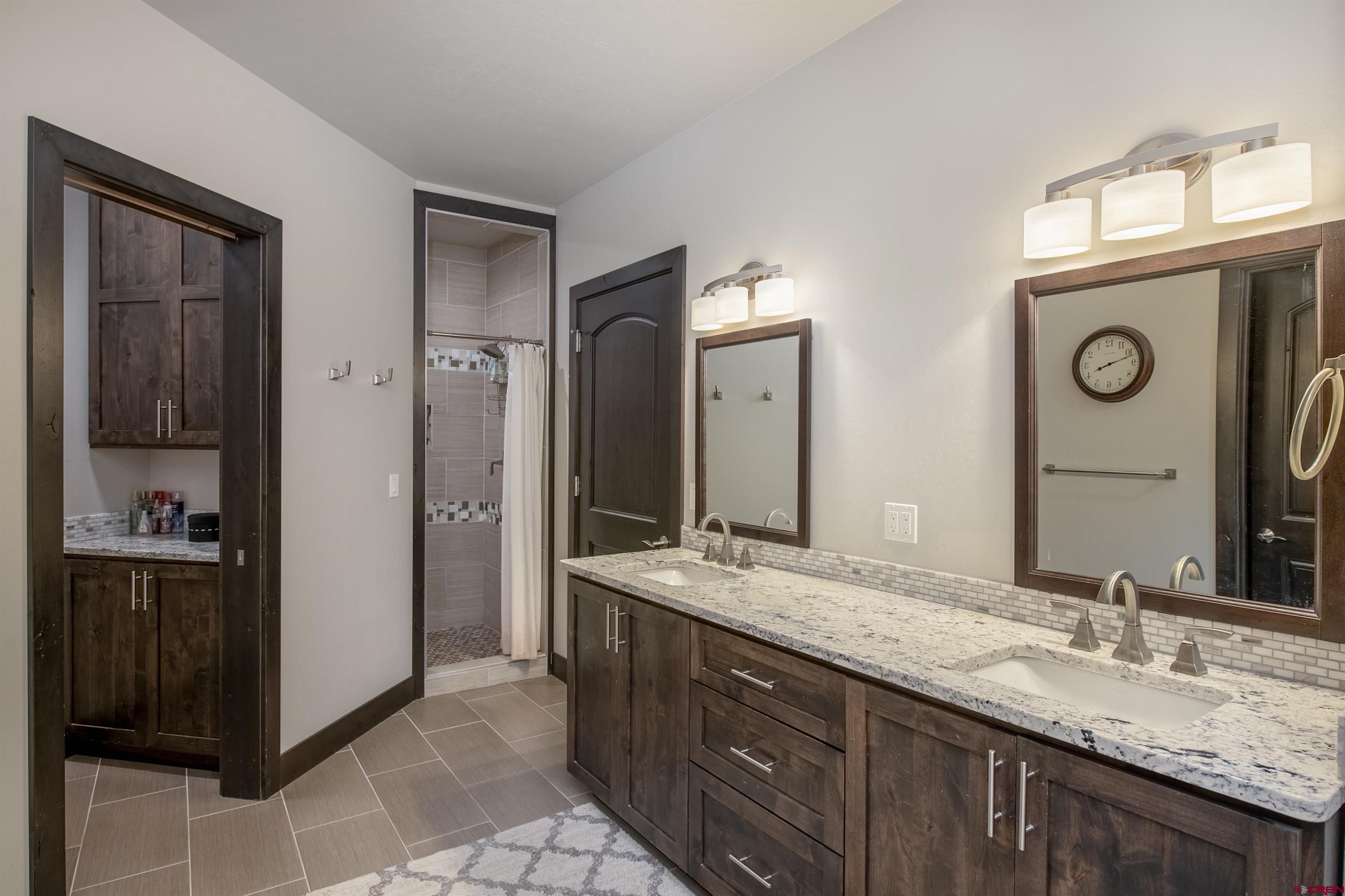 23 Jacquelyn Lane Crested Butte, CO 81224 - Photo 18 of 33 a bathroom with a granite countertop sink and a mirror
