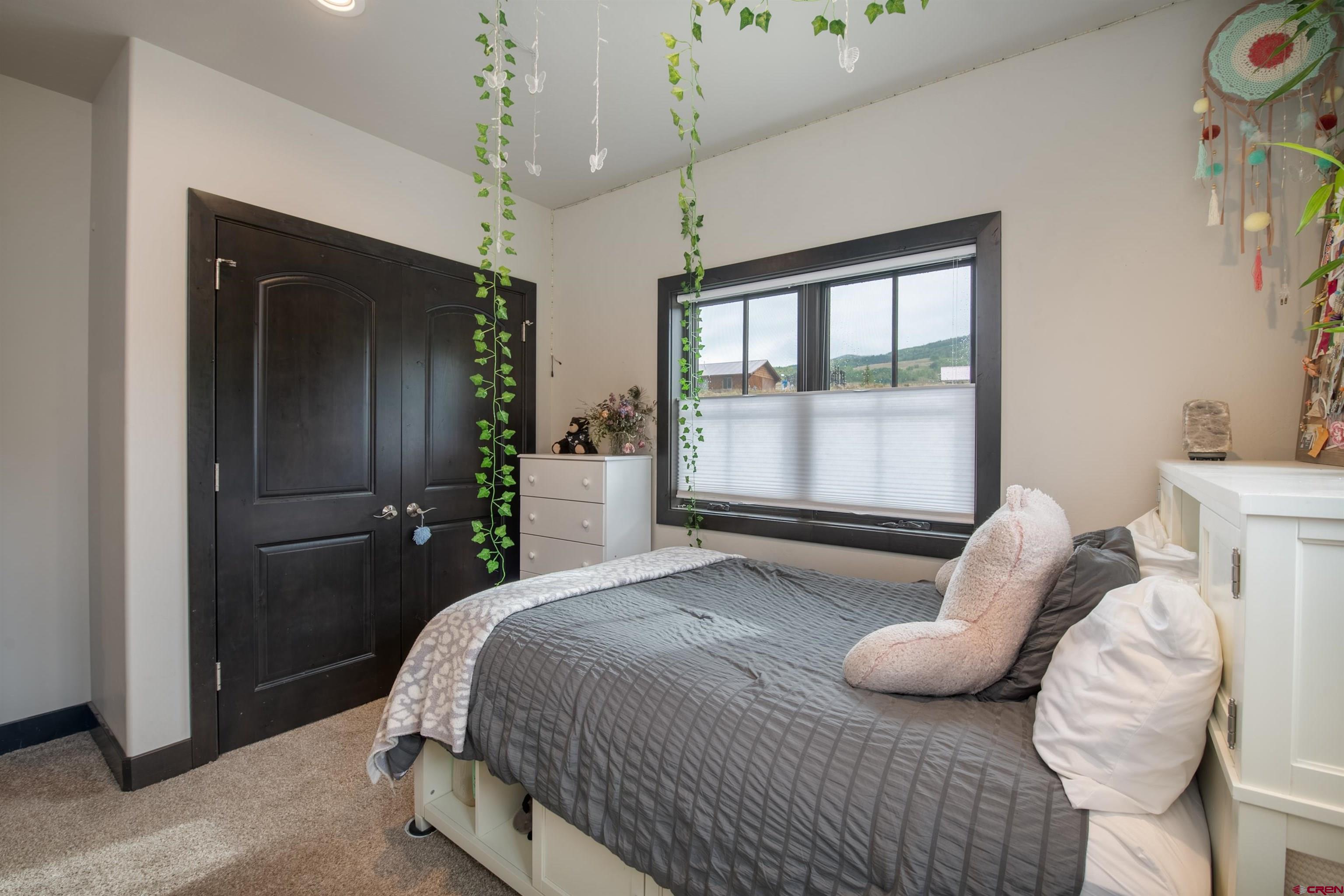 23 Jacquelyn Lane Crested Butte, CO 81224 - Photo 20 of 33 a bedroom with a bed and a window