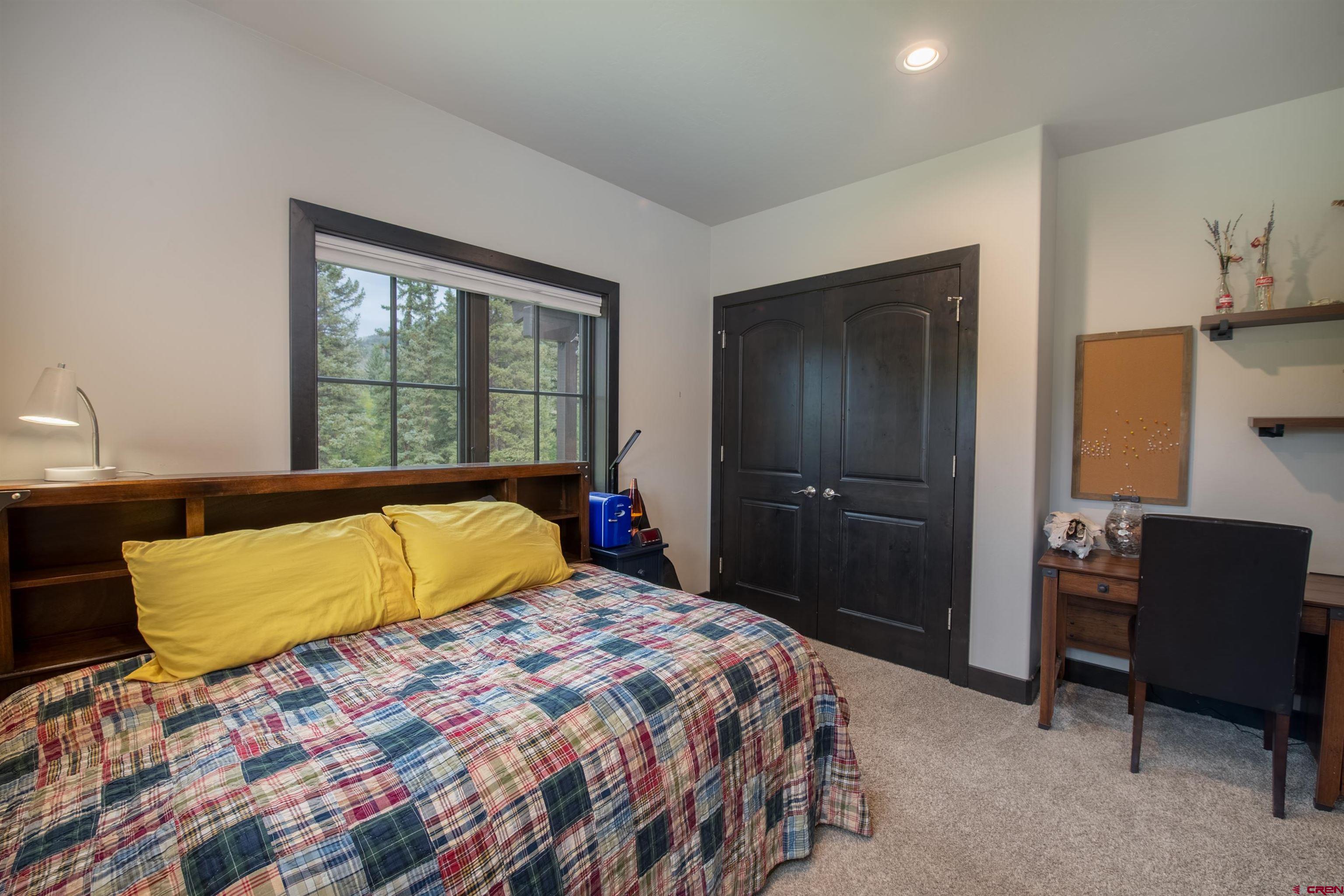 23 Jacquelyn Lane Crested Butte, CO 81224 - Photo 23 of 33 a bedroom with a bed dresser and a window