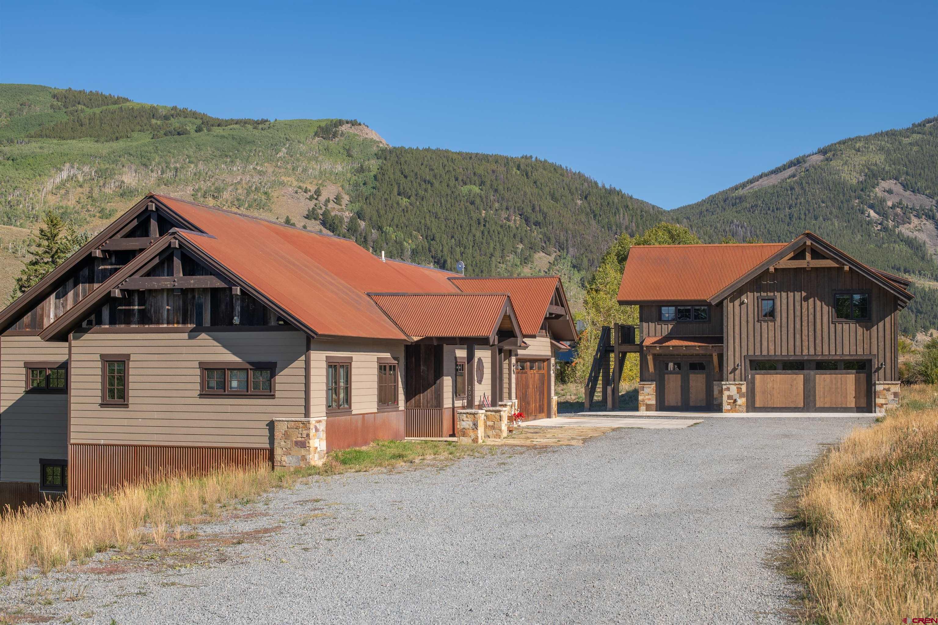 23 Jacquelyn Lane Crested Butte, CO 81224 - Photo 5 of 33 a front view of a house with a yard