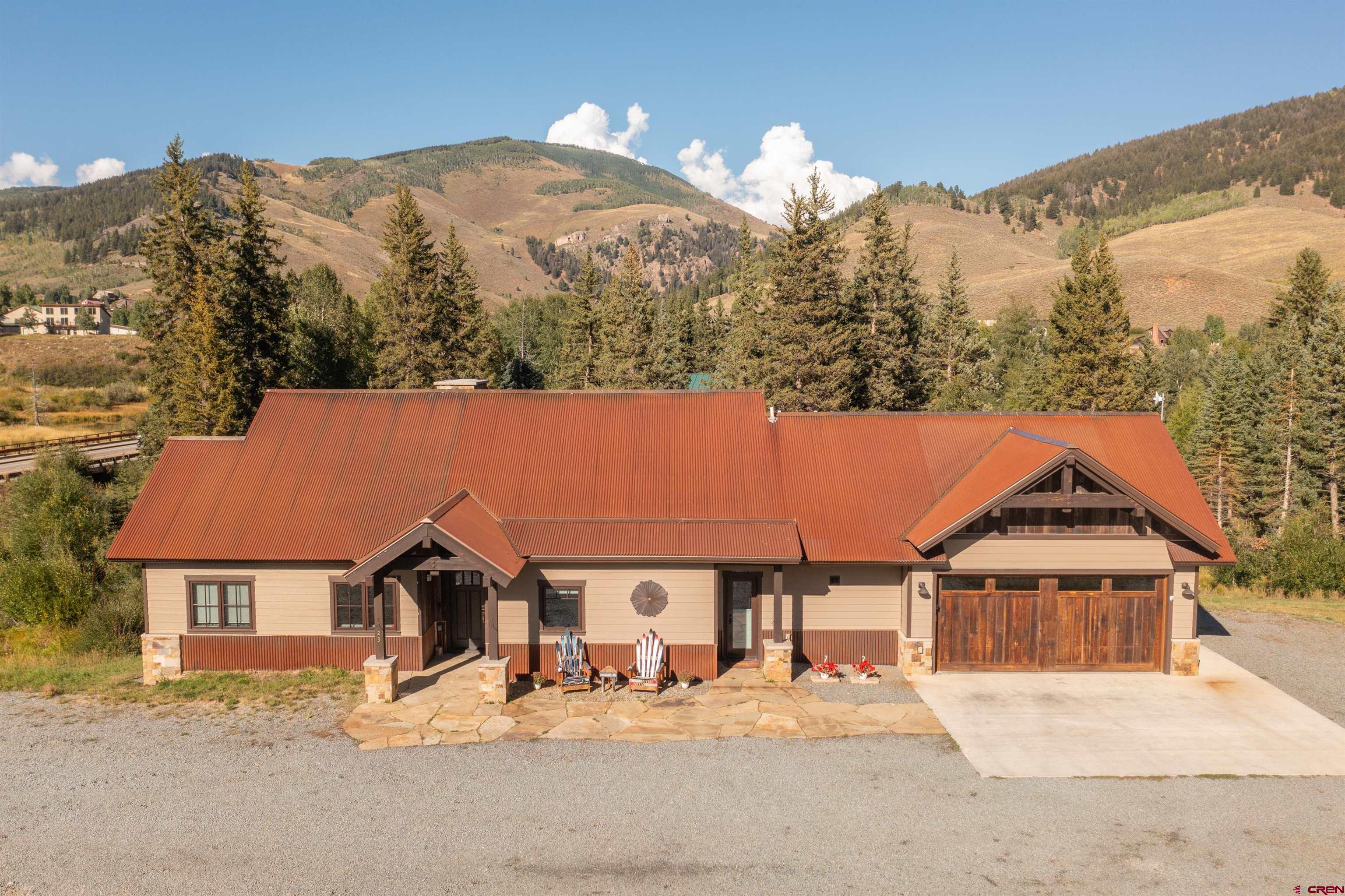 23 Jacquelyn Lane Crested Butte, CO 81224 - Photo 6 of 33 front view of a house with a yard and mountain view
