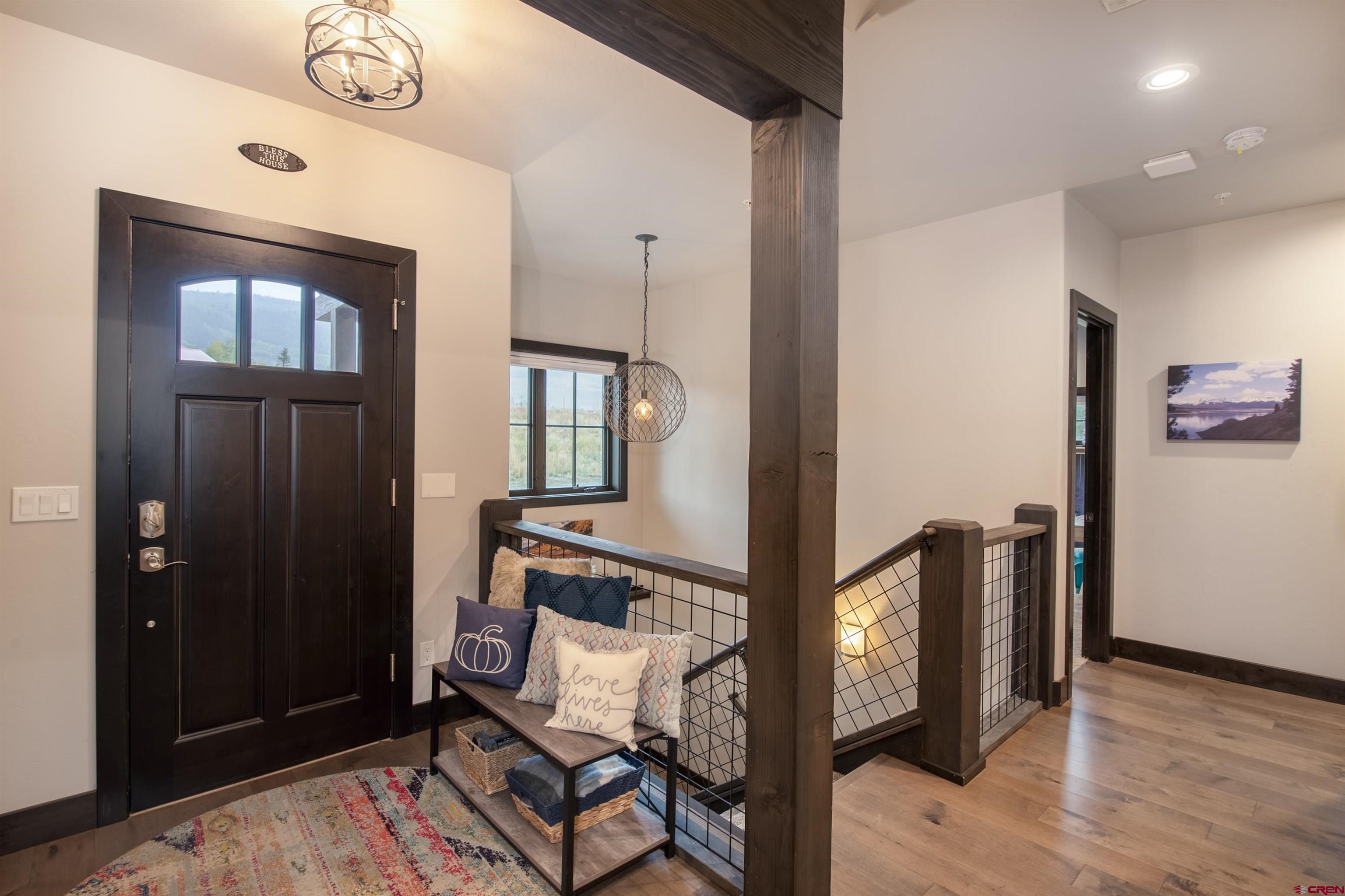 23 Jacquelyn Lane Crested Butte, CO 81224 - Photo 7 of 33 a view of a hallway with wooden floor and stairs