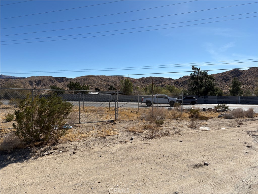 9825 Fobes Road Morongo Valley, CA 92256 - Photo 16 of 28 a view of a dry yard with wooden fence