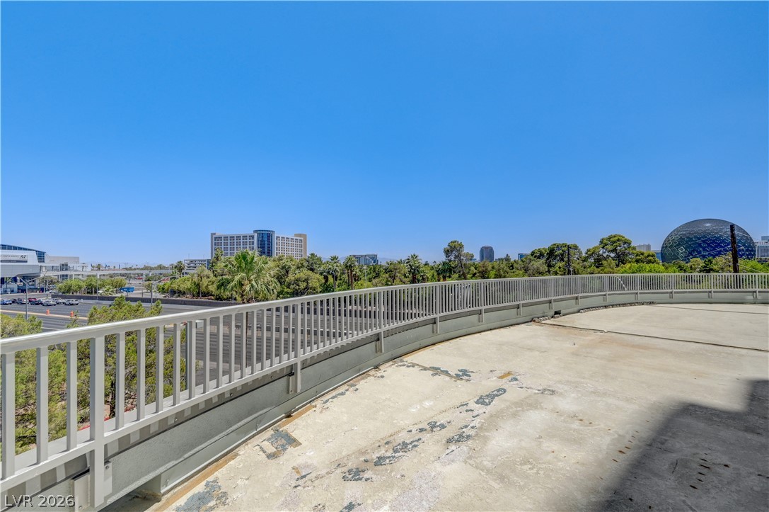 360 East Desert Inn Road, Unit 402 Las Vegas, NV 89109 - Photo 37 of 40 Urban panorama offers a dynamic view of city architecture and verdant tree lines from a spacious balcony.