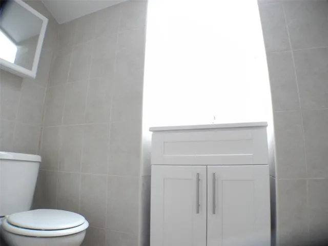 a white toilet sitting next to a white sink