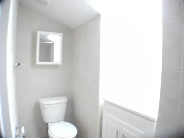 a white toilet sitting next to a white sink