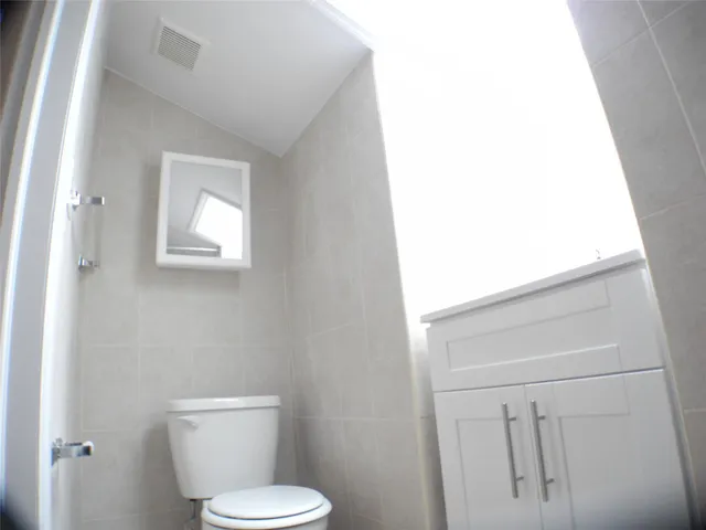 a white toilet sitting next to a white sink