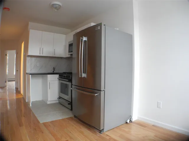 a kitchen with a refrigerator and a refrigerator