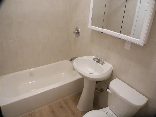 a white toilet sitting next to a bathroom sink