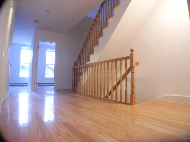 a view of an entryway with wooden floor