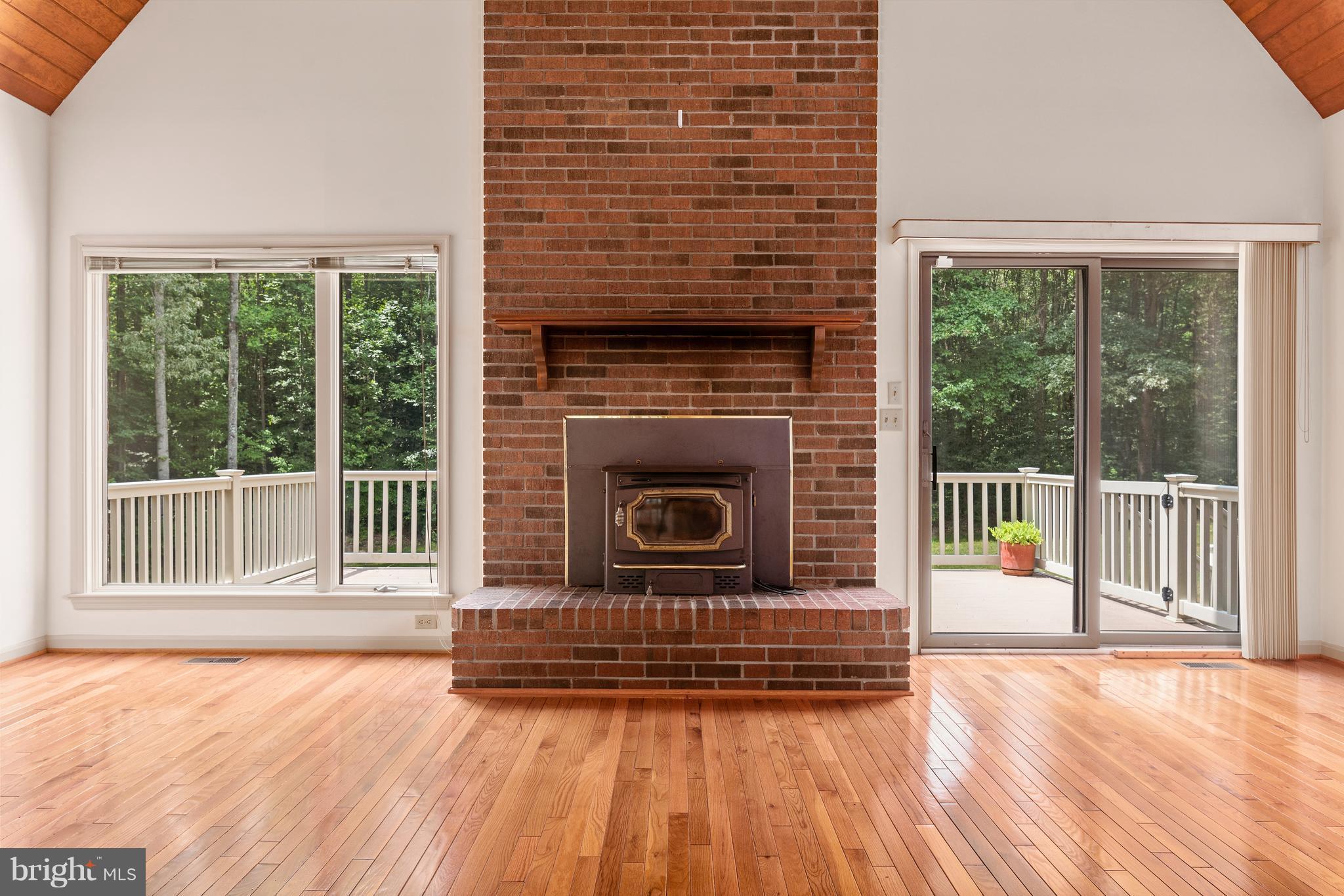 8484 Passapatanzy Road King George, VA 22485 - Photo 9 of 30 Stunning Fireplace Surrounded by Windows/Trex Deck