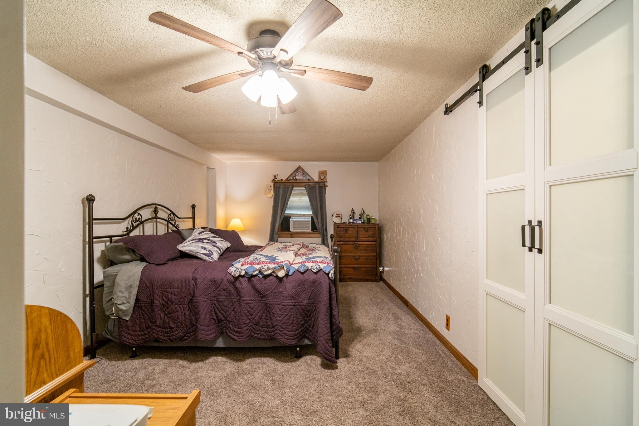 13127 Manor Furnace Road Brogue, PA 17309 - Photo 38 of 78 a bedroom with a bed and a chandelier