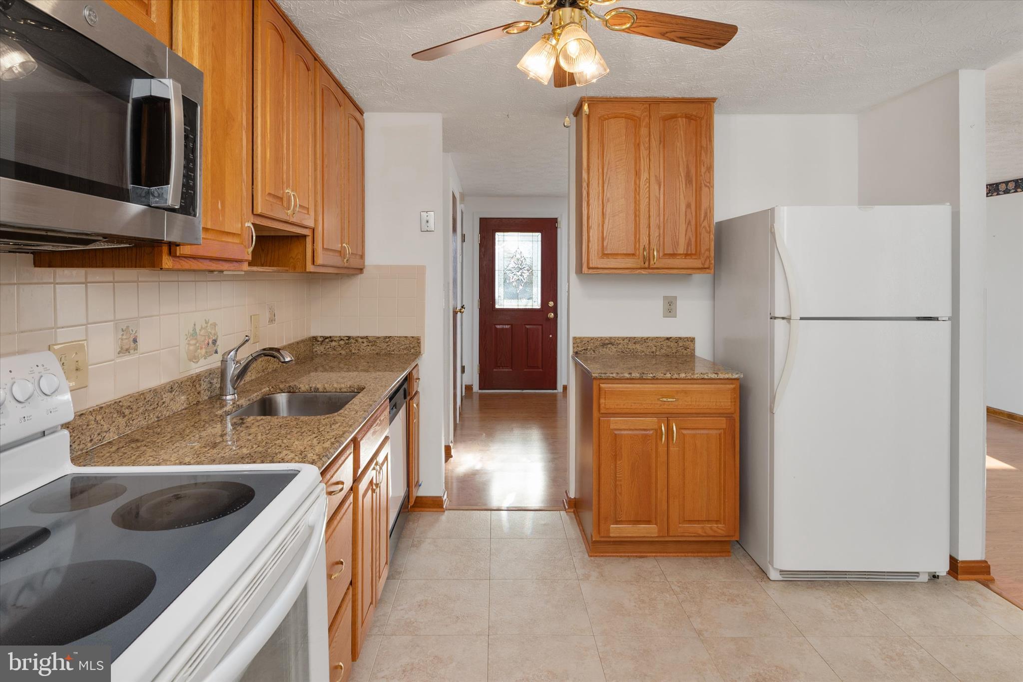 226 Compass Road Baltimore, MD 21221 - Photo 12 of 35 a kitchen with a sink stove and refrigerator