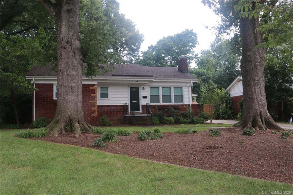 1100 Norland Road Charlotte, NC 28205 - Photo 1 of 13 a view of a yard in front of a house with large tree
