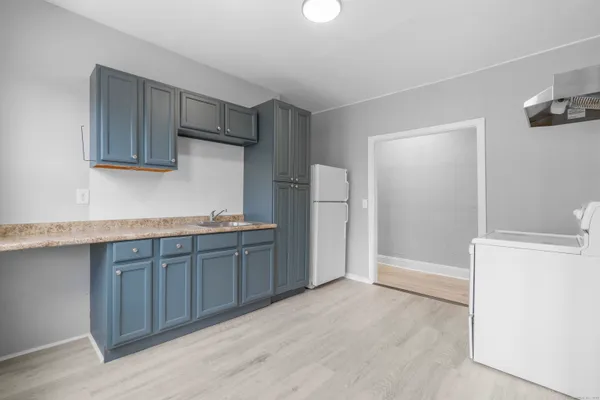 a kitchen with stainless steel appliances granite countertop a refrigerator and a sink