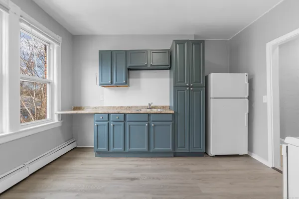 a kitchen with stainless steel appliances granite countertop a refrigerator and a stove top oven