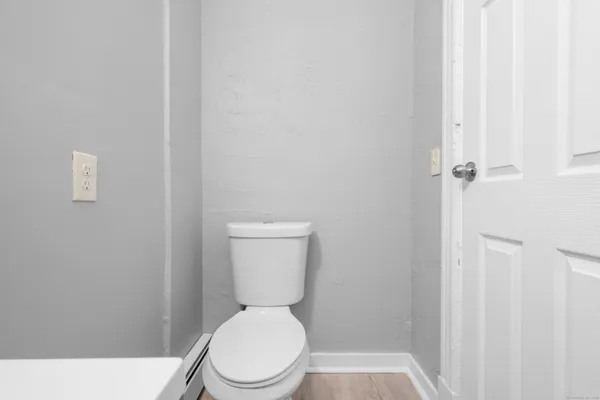 a white toilet sitting next to a bathroom sink