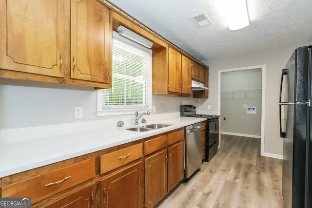 a kitchen with a sink stove and cabinets
