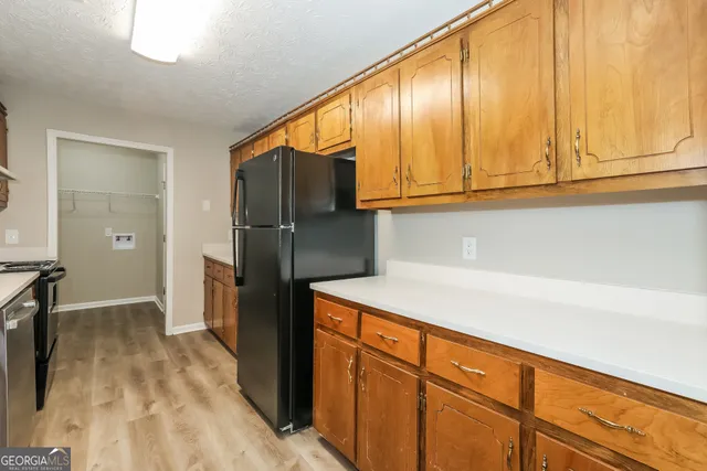 a kitchen with stainless steel appliances granite countertop a refrigerator and a sink