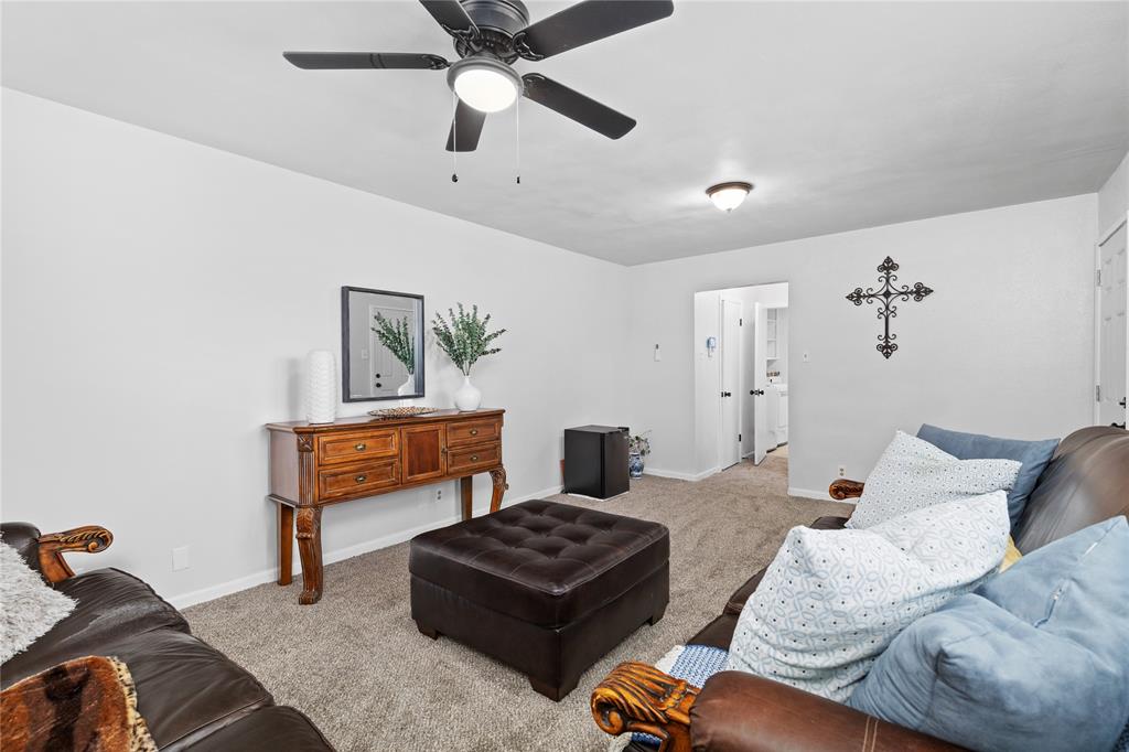2806 North Ricketts Street Sherman, TX 75092 - Photo 13 of 24 Living room featuring carpet flooring and a ceiling fan