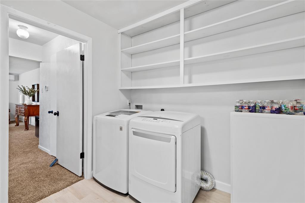 2806 North Ricketts Street Sherman, TX 75092 - Photo 17 of 24 Laundry area featuring light wood-type flooring, washing machine and clothes dryer, and light carpet