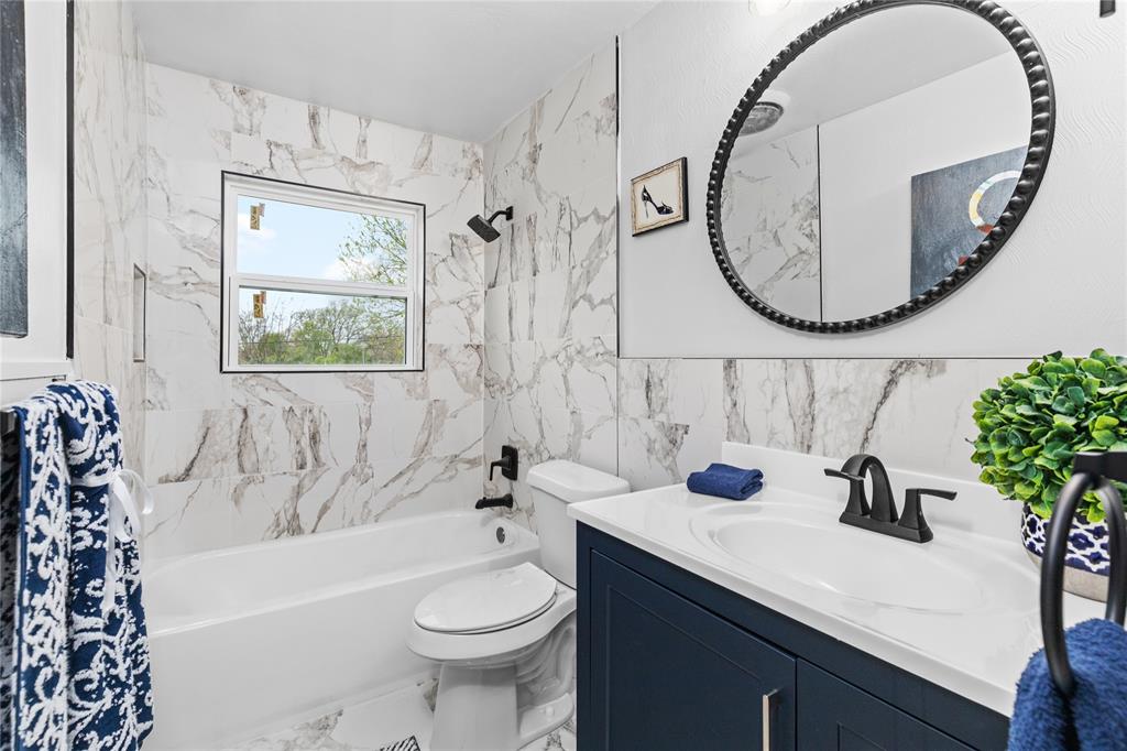 2806 North Ricketts Street Sherman, TX 75092 - Photo 21 of 24 Full bath featuring vanity, shower / washtub combination, and tile walls