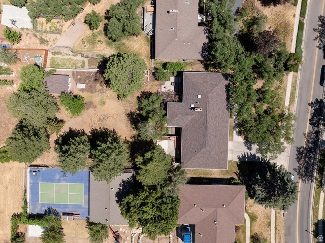 9676 Mt Jordan Road Sandy, UT 84092 - Photo 36 of 38 Property featuring a private tennis court with marked playing lines, mature trees, and a spacious lot