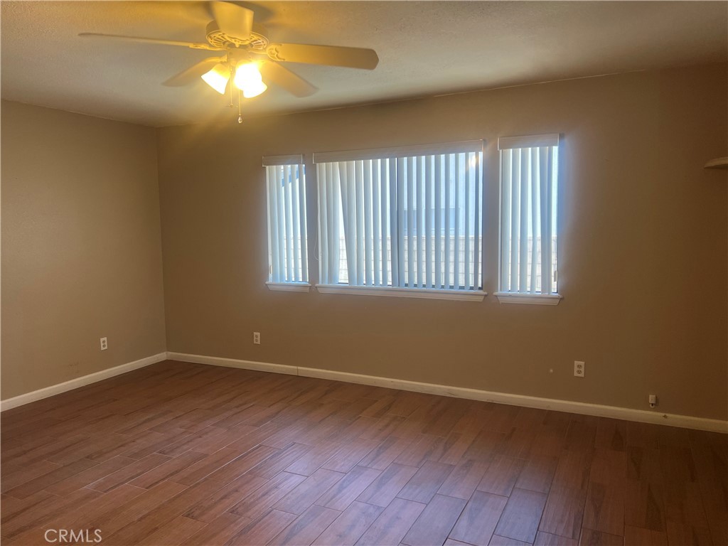 26682 Mainsail Lane Helendale, CA 92342 - Photo 8 of 13 a view of an empty room with wooden floor and a window