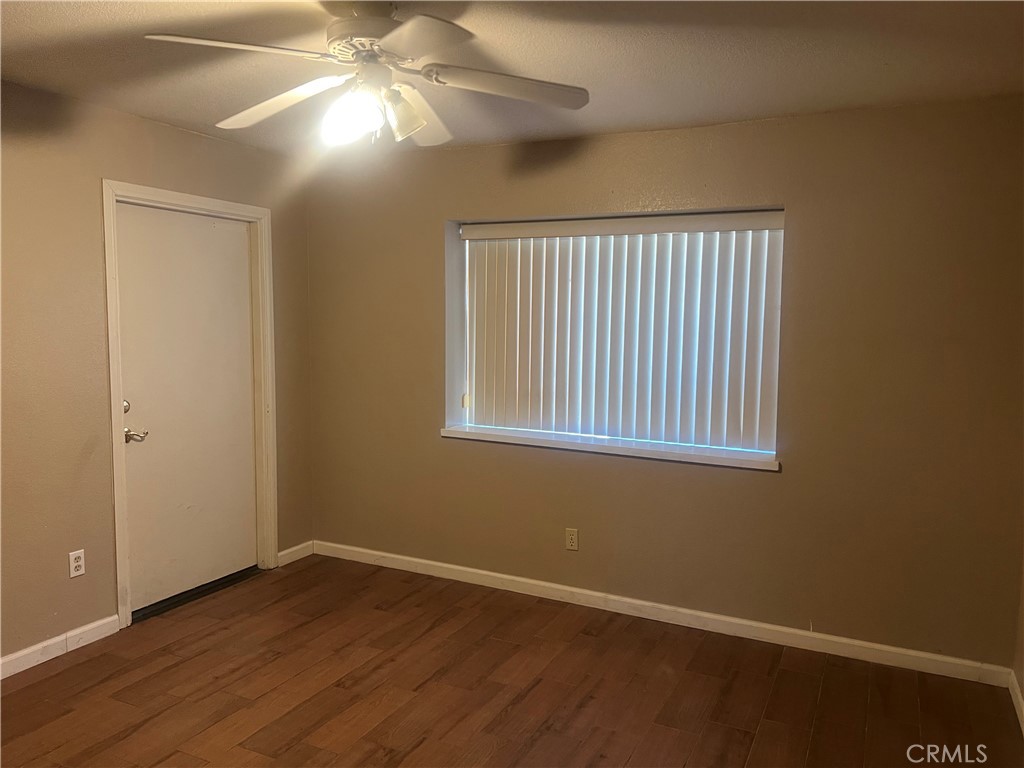 26682 Mainsail Lane Helendale, CA 92342 - Photo 10 of 13 a view of an empty room with wooden floor and a window