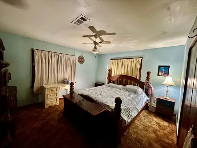 a bed room with a bed and a chandelier