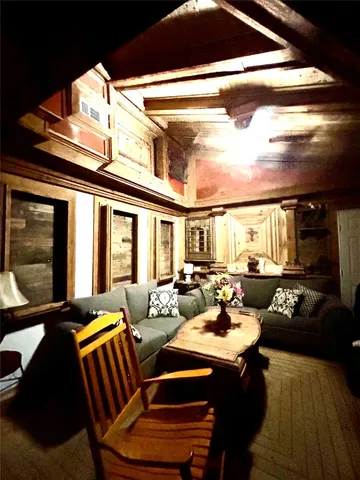 a living room with furniture and floor to ceiling windows