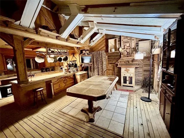 a living room with stainless steel appliances kitchen island granite countertop lots of wooden furniture