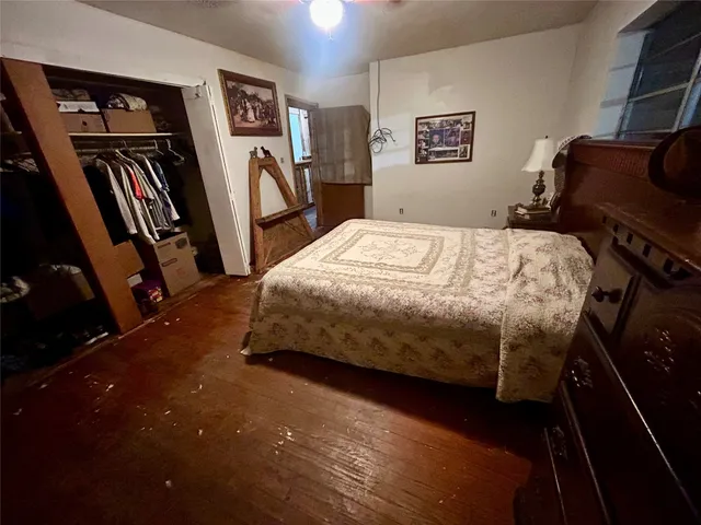 a bedroom with a bed furniture and a flat tv screen