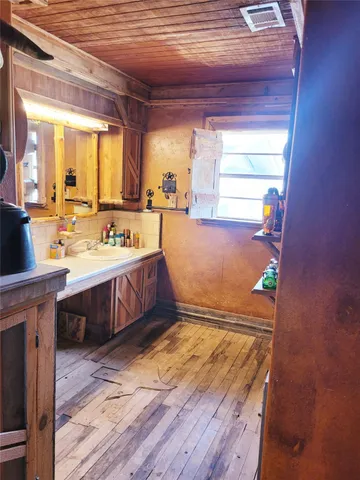a spacious bathroom with a tub sink and mirror
