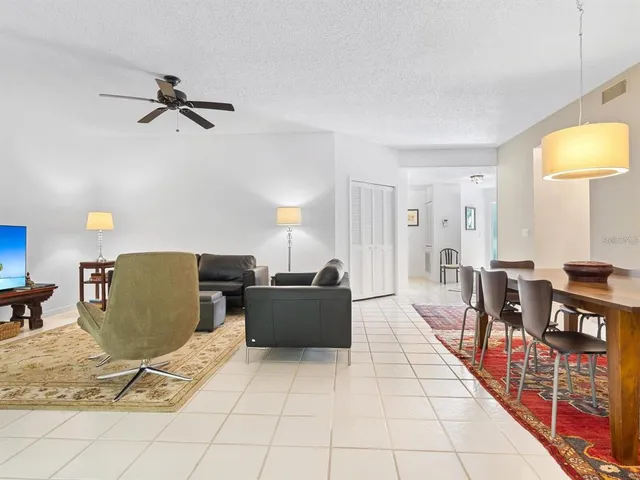 a living room with furniture and a dining table