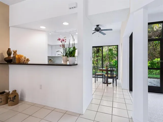 a hallway with a view of kitchen and dining room
