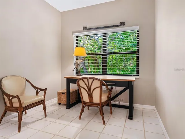 a view of a dining room with furniture and a window