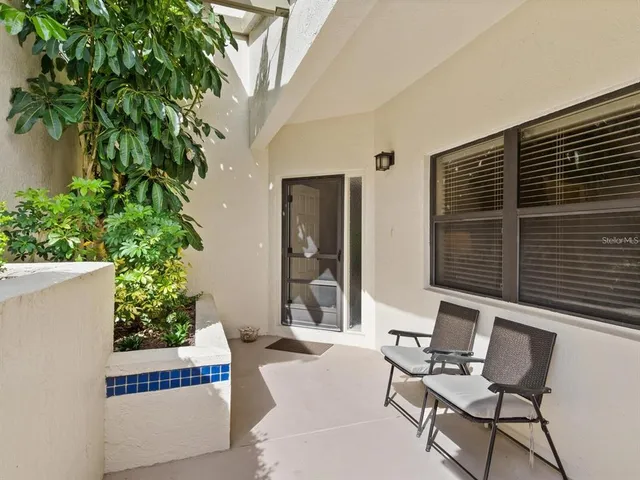 a view of a house with backyard sitting area and tub