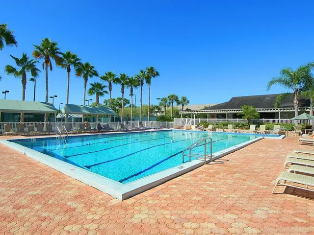 a view of a swimming pool with an outdoor seating