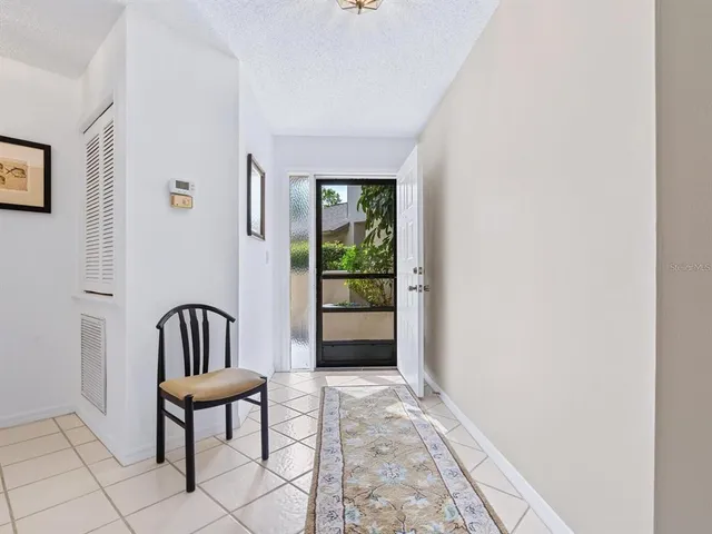 a view of a hallway with furniture and a window