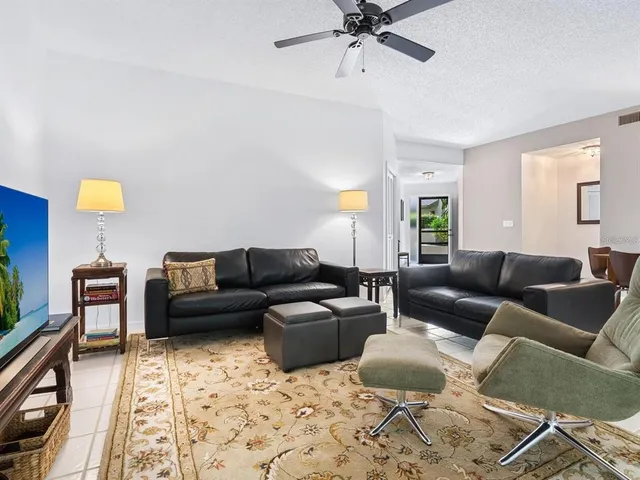 a living room with furniture and a ceiling fan