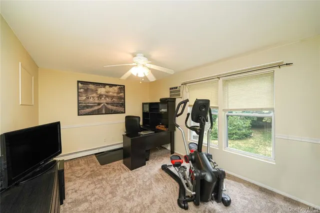 a view of a livingroom with furniture and a window