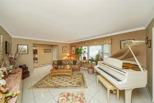 a living room with furniture and a floor to ceiling window