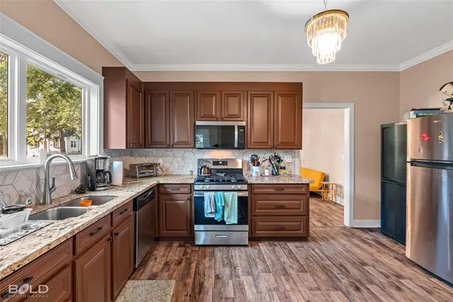 a kitchen with a sink stainless steel appliances and cabinets