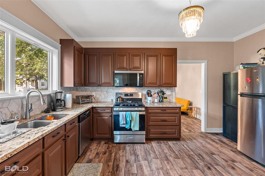 508 Chandler Street Minden, LA 71055 - Photo 20 of 35 a kitchen with a sink stainless steel appliances and cabinets